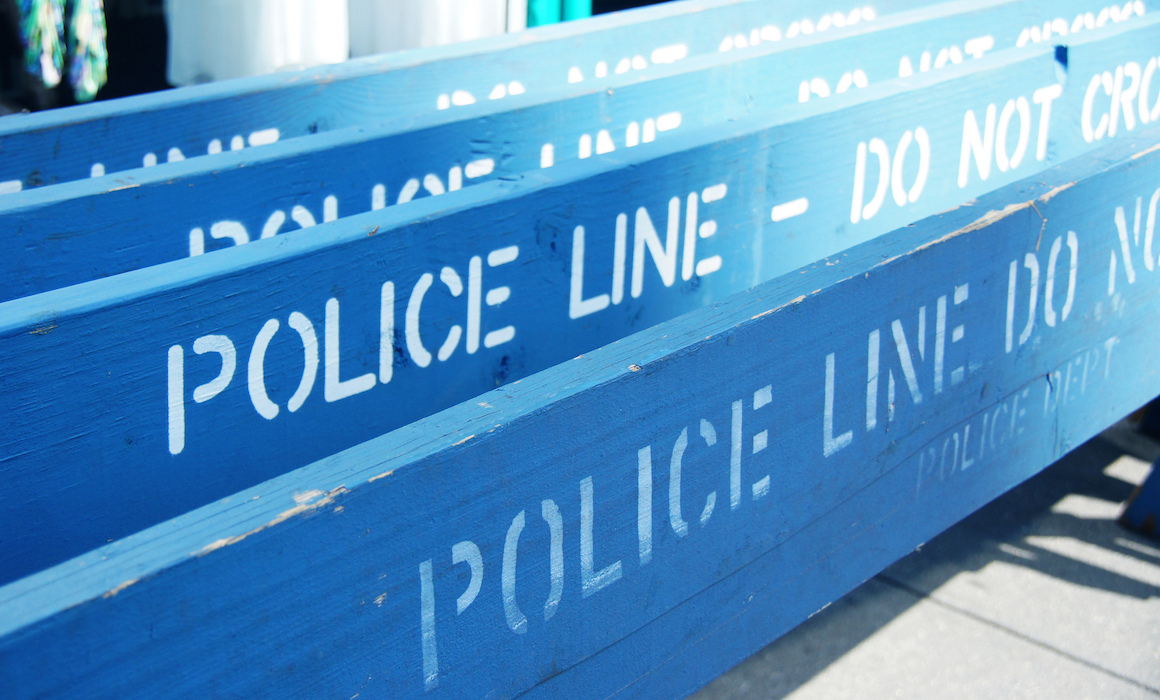 Four blue "Police Line" barricades