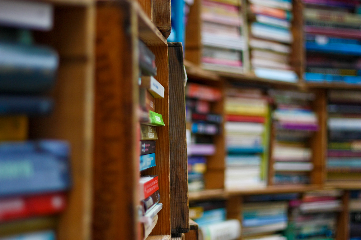 photo of a wooden bookshelf filled with books